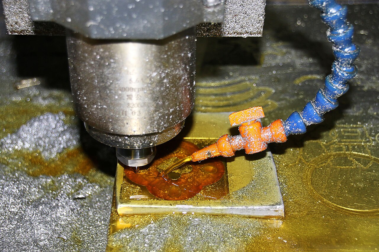 CNC milling machine cutting a metal workpiece in a toolroom